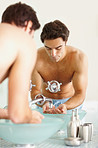 Young man at the basin washing his hands