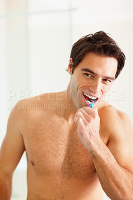 Buy stock photo Man brushing teeth in bathroom for dental wellness, morning routine and healthy gums at home. Happy guy with toothbrush, toothpaste and cleaning mouth for fresh breath, plaque and care of gingivitis 