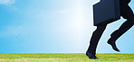 Business man running away with a briefcase on a field