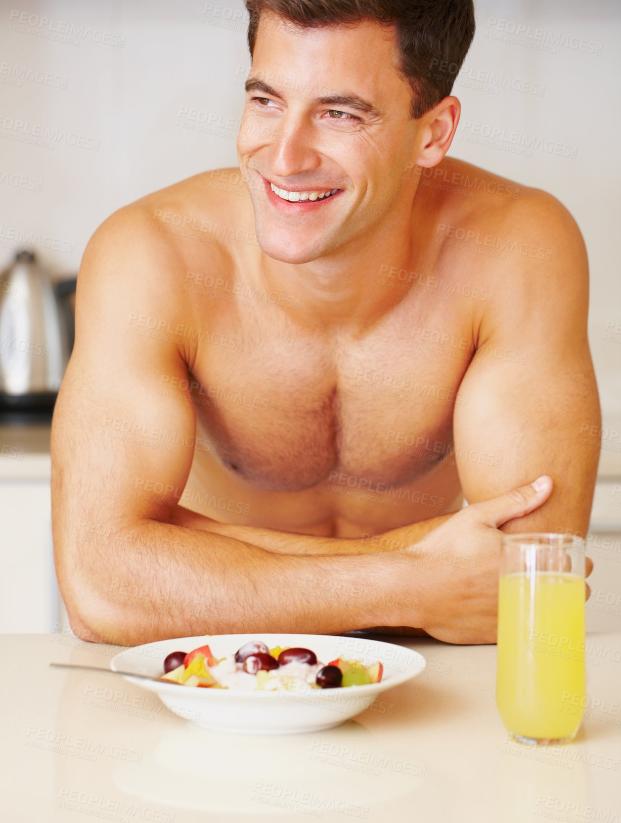 Buy stock photo Happy man, smile and fruit salad with juice in kitchen for delicious, nutrition or meal for breakfast. Male person, face and shirtless in excitement for fresh, organic or balanced diet for gut health