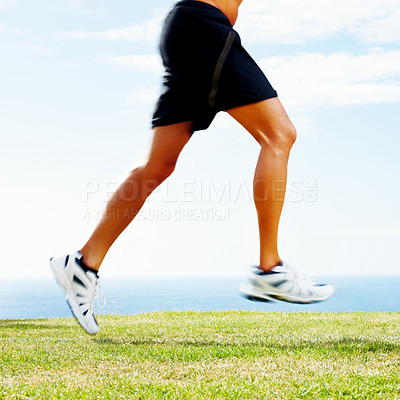 Buy stock photo Cropped image of a young guy running on the green grass against sky

