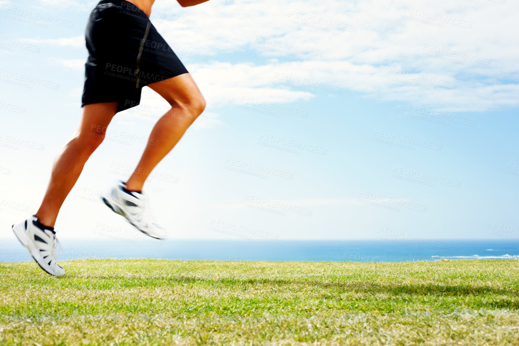 Buy stock photo Person, legs and running fitness with blue sky or sea view with workout sneakers, athlete or cardio. Training, sportswear and ocean horizon for summer health with outdoor performance, field or grass