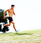 Muscular young man running outdoors - Copyspace
