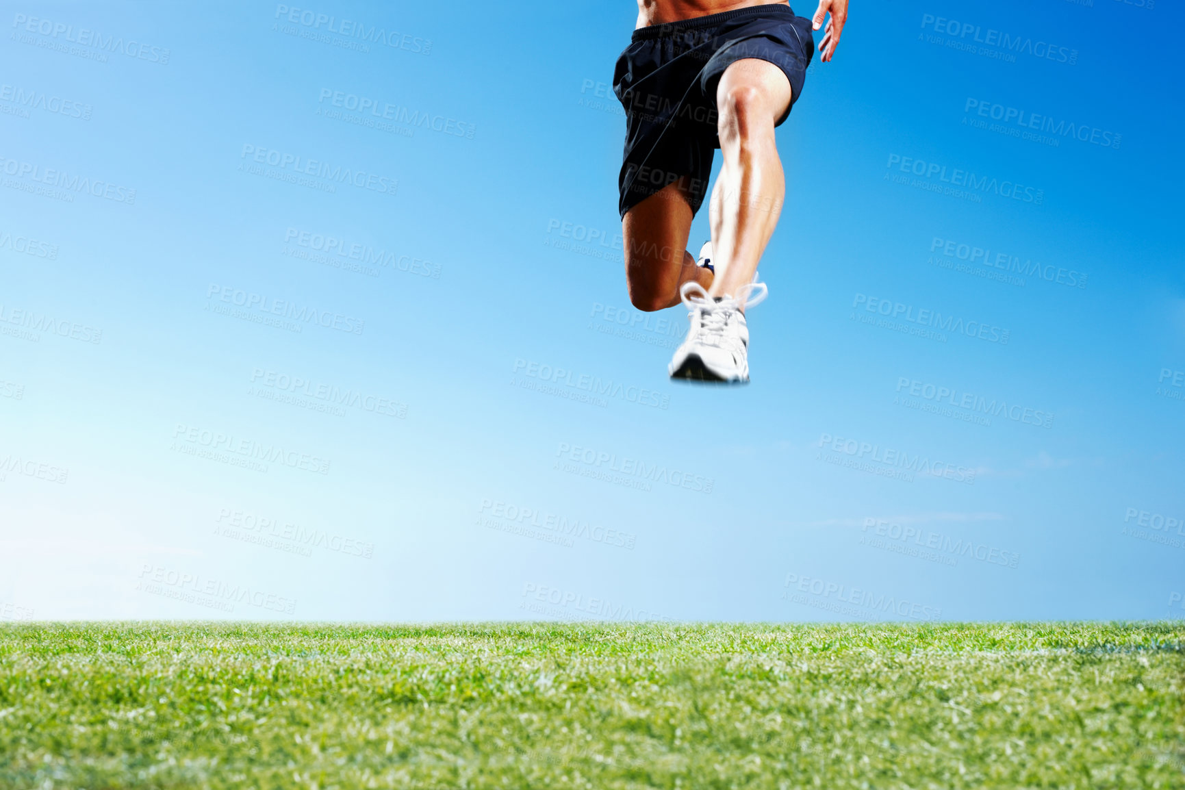 Buy stock photo Person, legs and running jump with blue sky on mockup space or workout sneakers, training or cardio. Athlete, leap and sportswear on grass field for fitness performance or marathon, health or outdoor