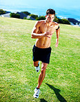 Young masculine man running on the grass - Outdoor