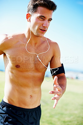 Buy stock photo Portrait of a handsome young guy running against the sky