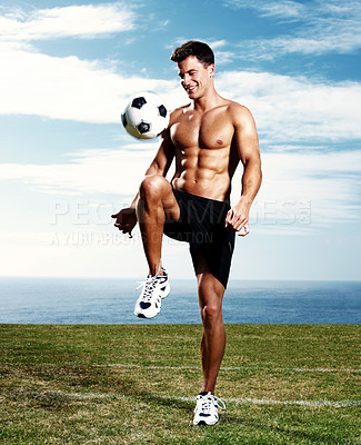 Buy stock photo Portrait of a happy young man on field playing with a soccer ball - Copyspace
