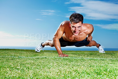 Buy stock photo Portrait of a young guy doing single handed pushups on the grass field - Copyspace
