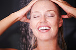 Closeup of a happy female taking a shower