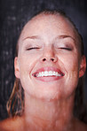 Closeup of a happy female in a bath against black