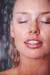 Closeup of a young woman taking a shower