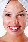 Closeup of a smiling woman with a towel wrapped on head