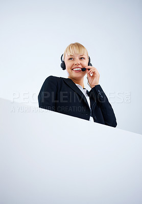 Buy stock photo Mockup, smile and a call center woman in studio on a white background for help, crm or telemarketing. Space, customer support and headset with a happy young employee with poster for sales service