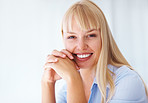 Business woman smiling with hands clasped
