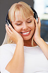 Woman with eyes closed listening to music