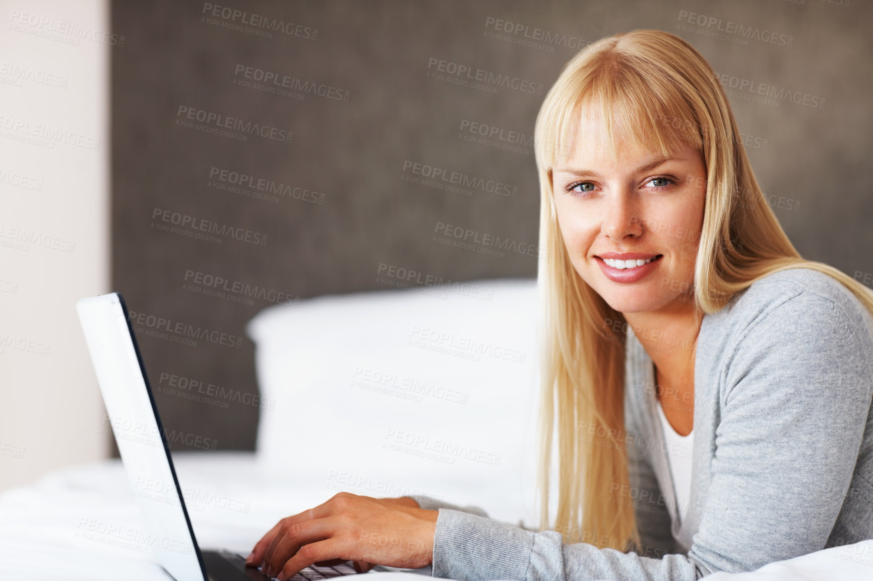 Buy stock photo Happy woman, portrait and relax with laptop on bed for browsing, writing or email at home. Young female person or blonde lying with smile on computer for morning or communication in bedroom at house