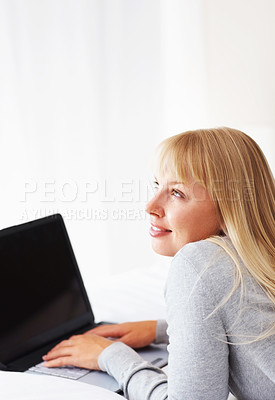 Buy stock photo Thinking, idea and happy woman with laptop for relax, social media and networking in home. Female student, and person with technology, research and online app with internet for study with mockup