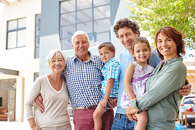 Buy stock photo Portrait of a happy multi-generational family standing together outside