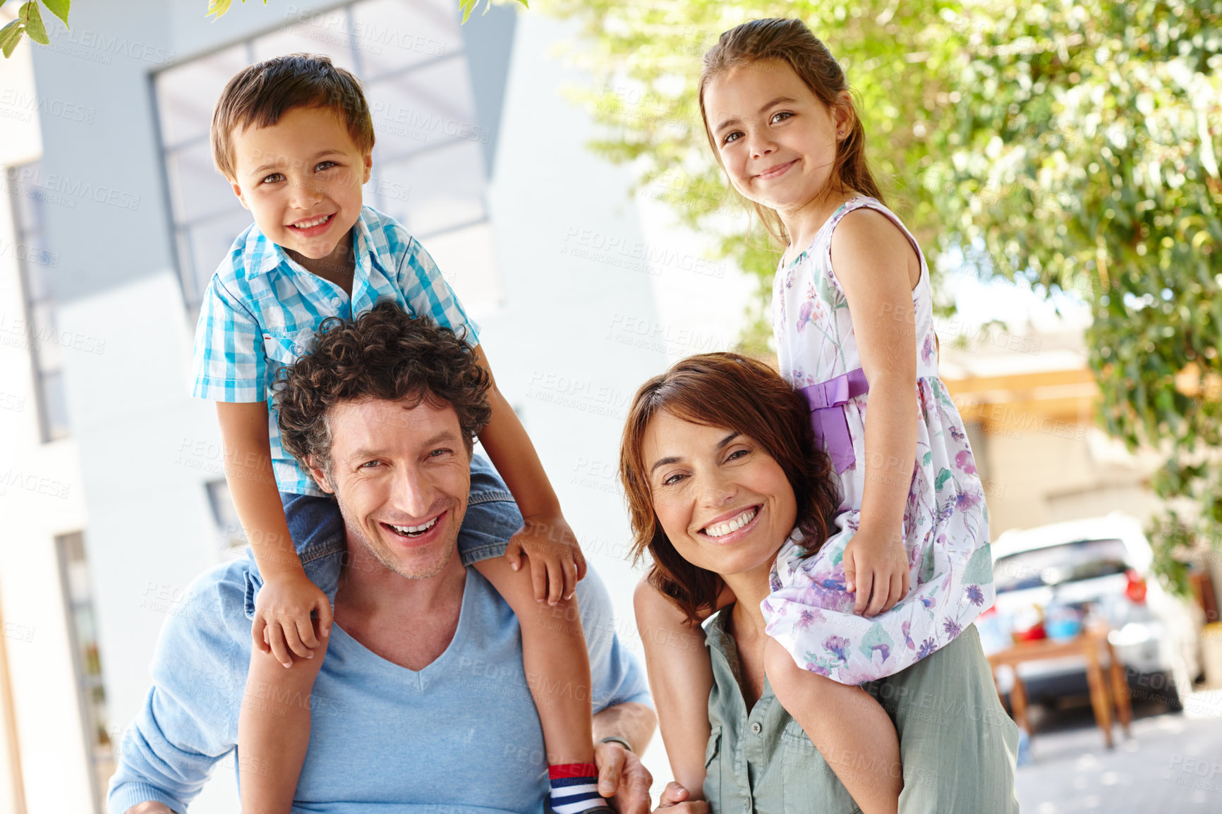 Buy stock photo Shoulder carrying, portrait and parents with children, backyard and bonding on weekend or affection. Happy, kids and people on break with family, son and daughter at vacation house, outdoor and USA