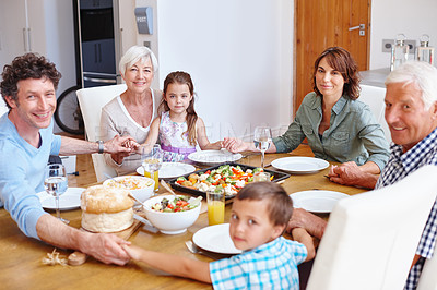 Buy stock photo Shot of a multi-generational family having a meal together