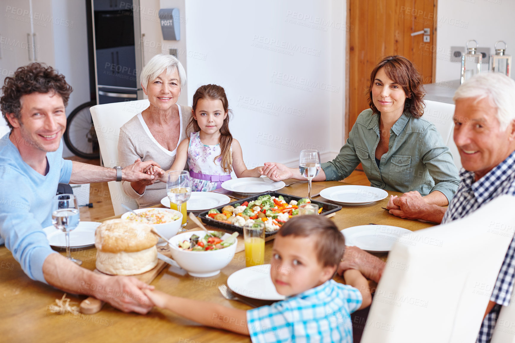 Buy stock photo Shot of a multi-generational family having a meal together