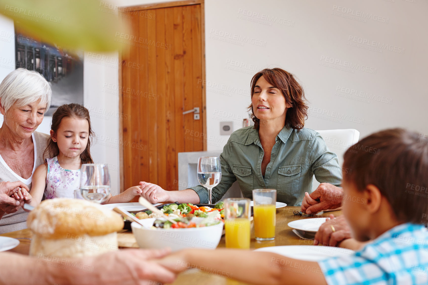 Buy stock photo Shot of a multi-generational family having a meal together