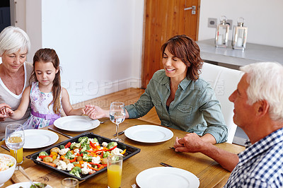 Buy stock photo Shot of a multi-generational family having a meal together