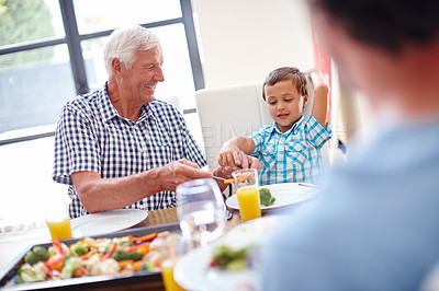 Buy stock photo Shot of a family enjoying a meal together