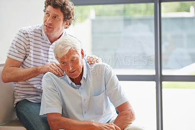 Buy stock photo Shot of a man massaging his father's neck