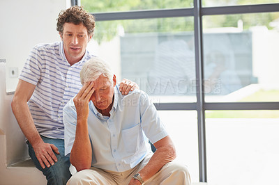 Buy stock photo Shot of a man offering support to his father