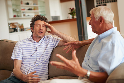 Buy stock photo Shot of a man and his father having an argument