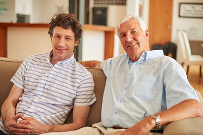 Buy stock photo Shot of a man and his father sitting together on the sofa at home