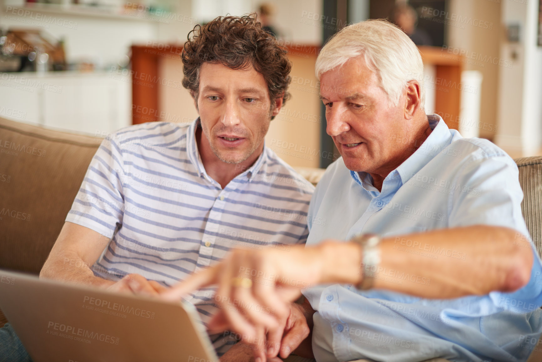 Buy stock photo Shot of a man and his father sitting with a laptop indoors
