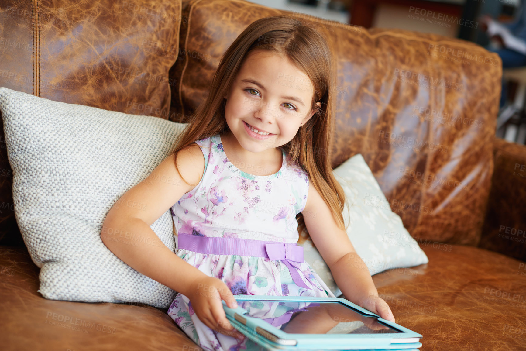 Buy stock photo Shot of a little girl using a digital tablet at home