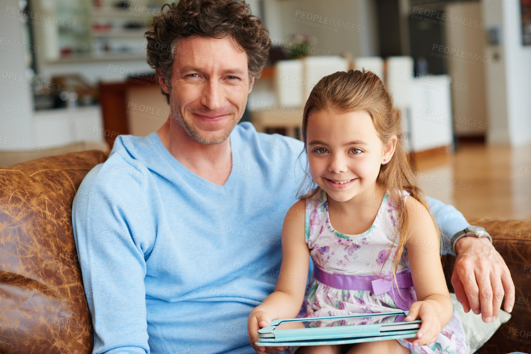 Buy stock photo Shot of a little girl and her dad using a digital tablet at home