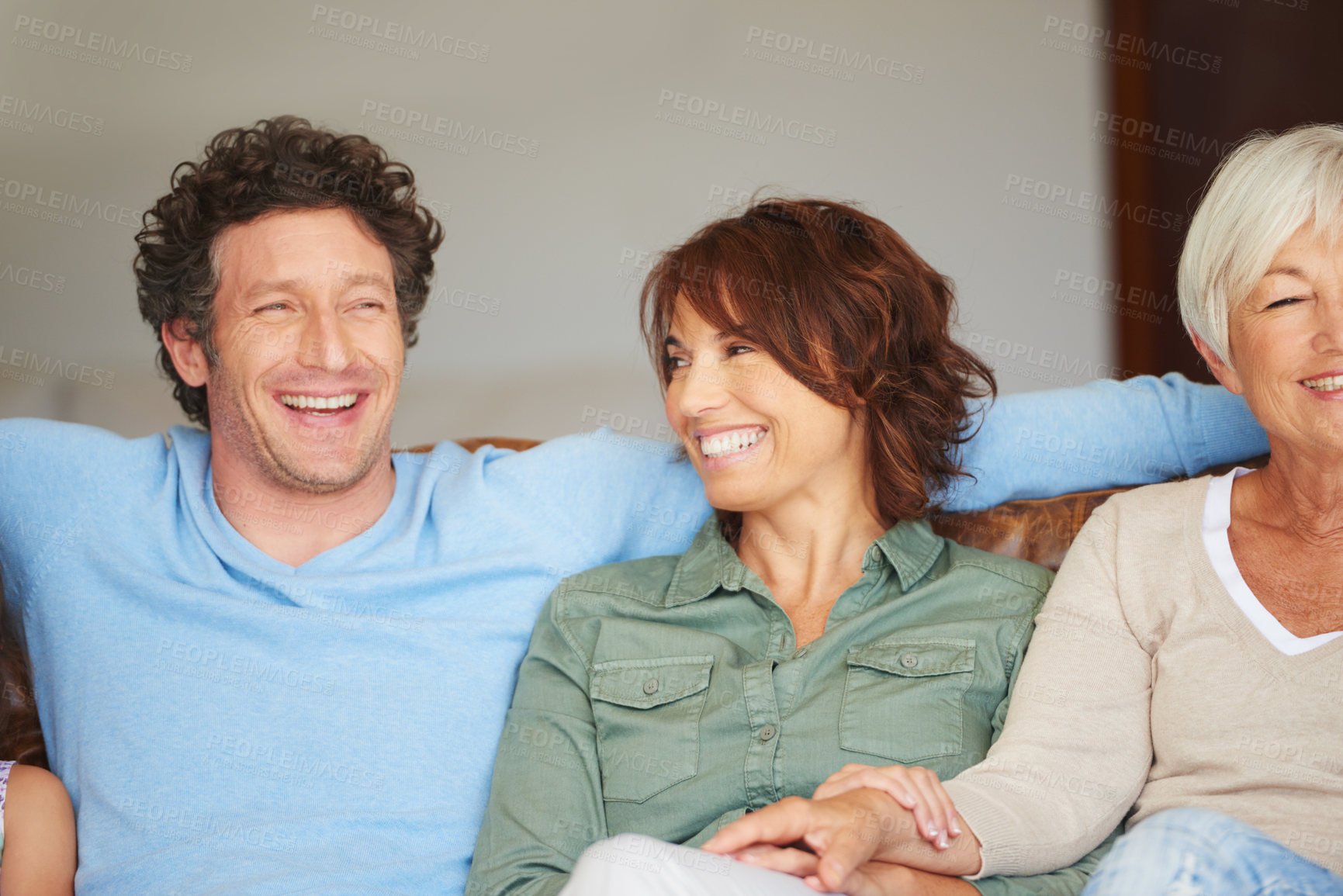 Buy stock photo Shot of a young woman sitting beside her husband and her mother