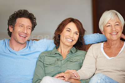 Buy stock photo Shot of a young woman sitting beside her husband and her mother