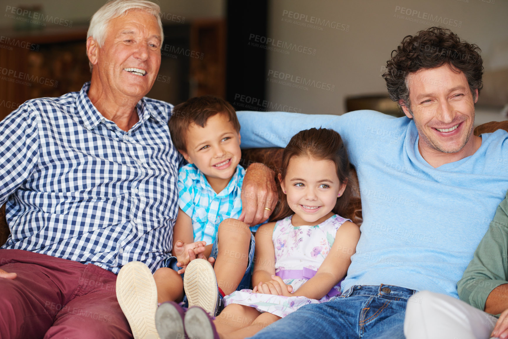 Buy stock photo Shot of two children sitting with their father and grandfather indoors