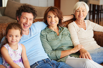 Buy stock photo Shot of a happy multi-generational family sitting together on a sofa