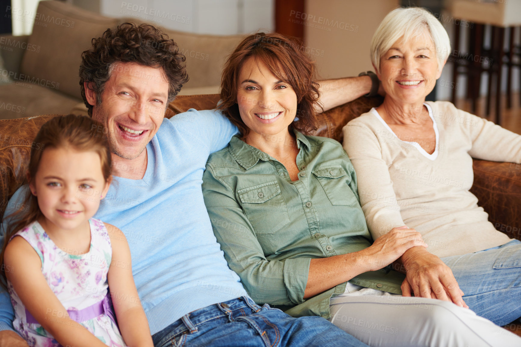 Buy stock photo Shot of a happy multi-generational family sitting together on a sofa