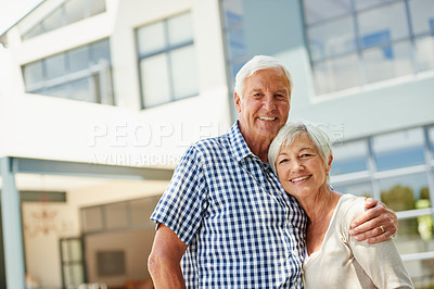 Buy stock photo Shot of a happy senior couple standing together outside