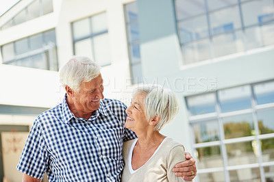 Buy stock photo Shot of a happy senior couple standing together outside