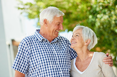 Buy stock photo Shot of a loving senior couple standing together outside