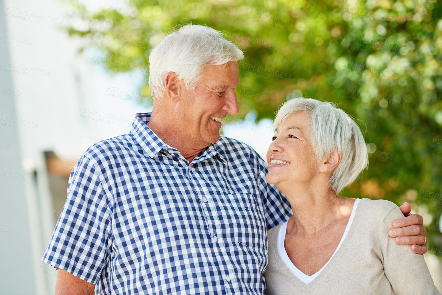 Buy stock photo Shot of a loving senior couple standing together outside