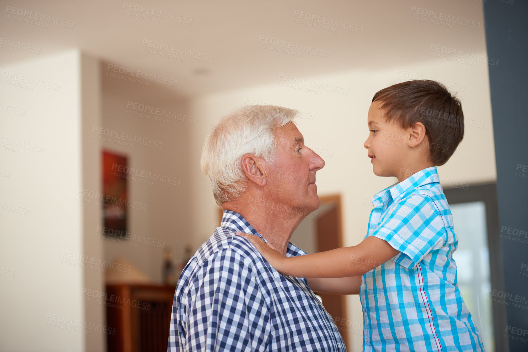 Buy stock photo Shot of a little boy bonding with his grandfather