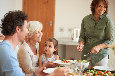 Buy stock photo Shot of a multi-generational family having lunch together
