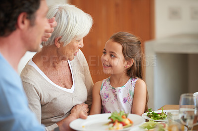 Buy stock photo Shot of a multi-generational family having lunch together