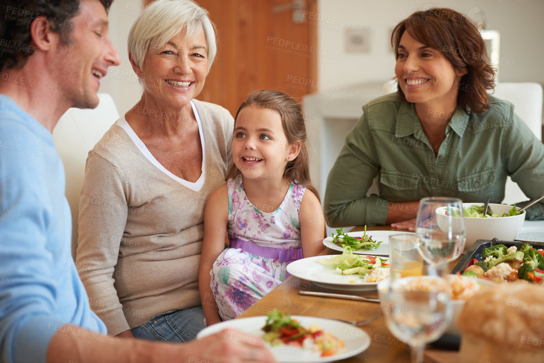 Buy stock photo Shot of a multi-generational family having lunch together