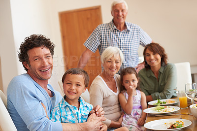 Buy stock photo Portrait of a multi-generational family having lunch together at home