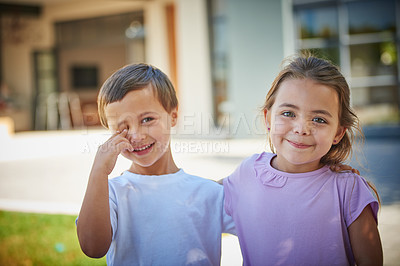 Buy stock photo Portrait of a young brother and sister standing together outside their house
